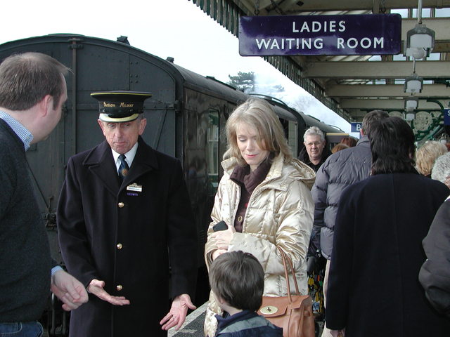 The Station Master talking to a young boy at Sheringham steam railway station

