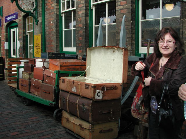 Anna Cristalino with old fashioned trunks and cases at Sheringham steam railway station
