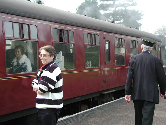 Ann Beeching with the Station Master walking past her. On board the private coach is Joyce Allum
