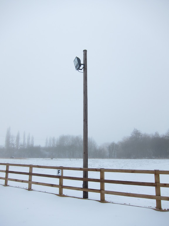 One of the 4 floodlights for the menage is mounted on to old BT telegraph posts
